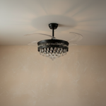 A matte black drum frame ceiling fan with cascading crystals and retractable clear acrylic blades.