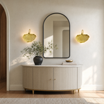 A sculptural metal wall sconce shaped like a ginkgo leaf with a textured gold finish and a curved neck.