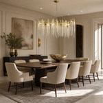 A Yiosi gold metal branch chandelier with cascading crystal beads suspended in a rainfall arrangement.