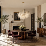 A modern organic branch chandelier with a warm gold metal frame and frosted white crystal petal accents.