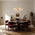 A tiered chandelier with a warm brass branch frame and petal-shaped frosted glass shades.
