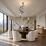 A matte black metal vine branch pendant light with frosted glass floral blossoms suspended from a ceiling mount.