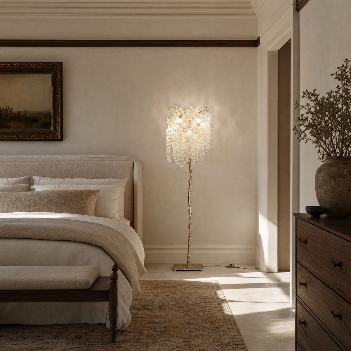 A gold metal tree floor lamp with cascading clear crystal drops standing on a square brass base.