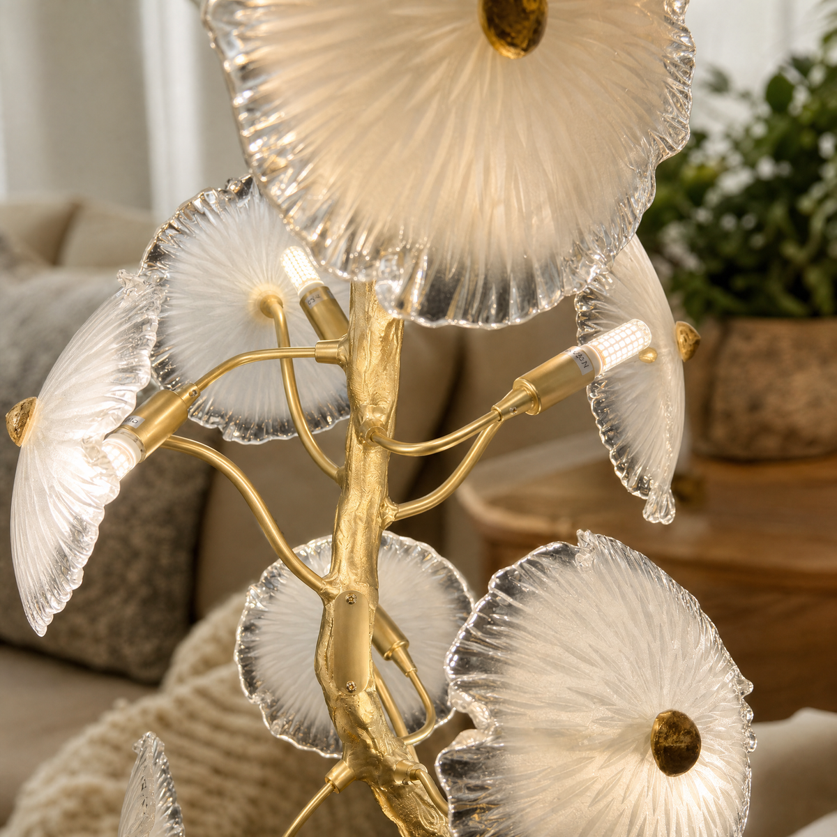 A Yiosi floor lamp with a gold brass organic branch stem and clear fluted glass flower petal shades.
