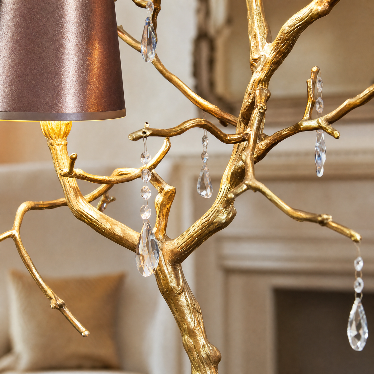 A decorative table lamp with a textured gold branch frame, hanging clear crystal droplets, and dual teal and purple shades.