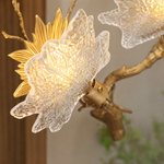 A Yiosi gold metal wall sconce featuring a maple branch design with three floral glass petal shades for ambient lighting.