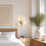 A contemporary wall sconce with three frosted glass discs clustered on a sculptural, branching arm with a warm brass finish.