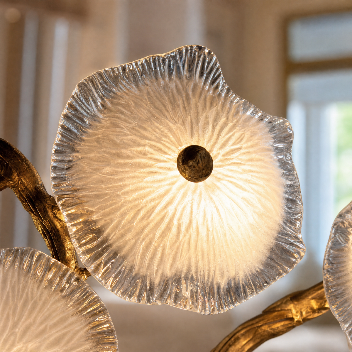 A modern wall sconce featuring an antique brass branch-like metal frame adorned with textured circular glass blossom shades.