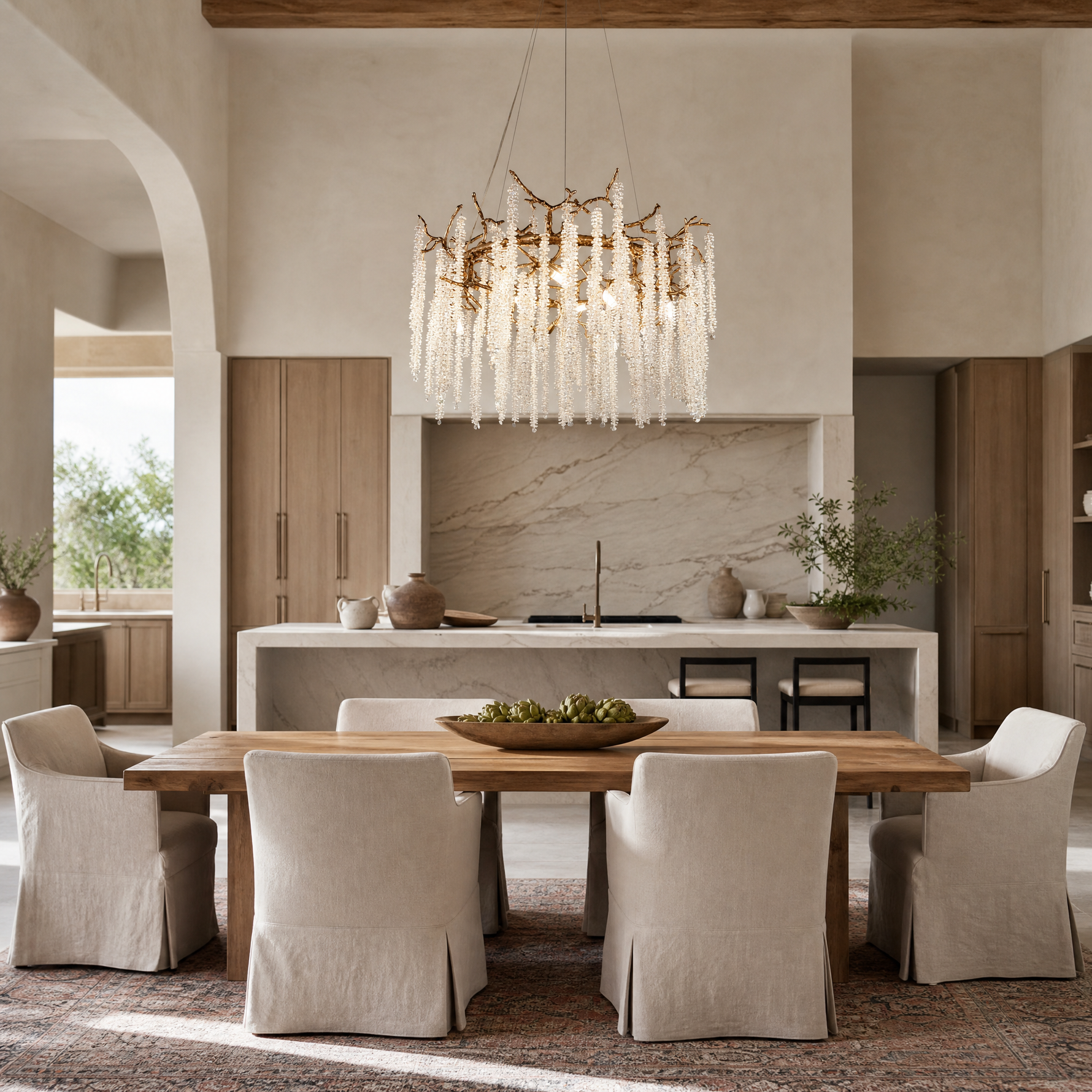 A circular antique gold branch chandelier with cascading crystal bead strands hangs from the ceiling in a lit room.