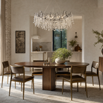 A modern matte black metal branch chandelier adorned with cascading clear crystal drops in a circular shape.