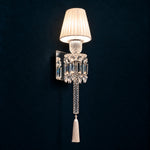 Avelle Ivory Tasseled Crystal 1-Light Wall Sconce 6.7" on a deep teal-blue wall