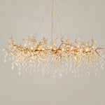Crystal Chandelier Modern Gold Branch Metal 18-Light for Dining Room on a light warm plaster wall