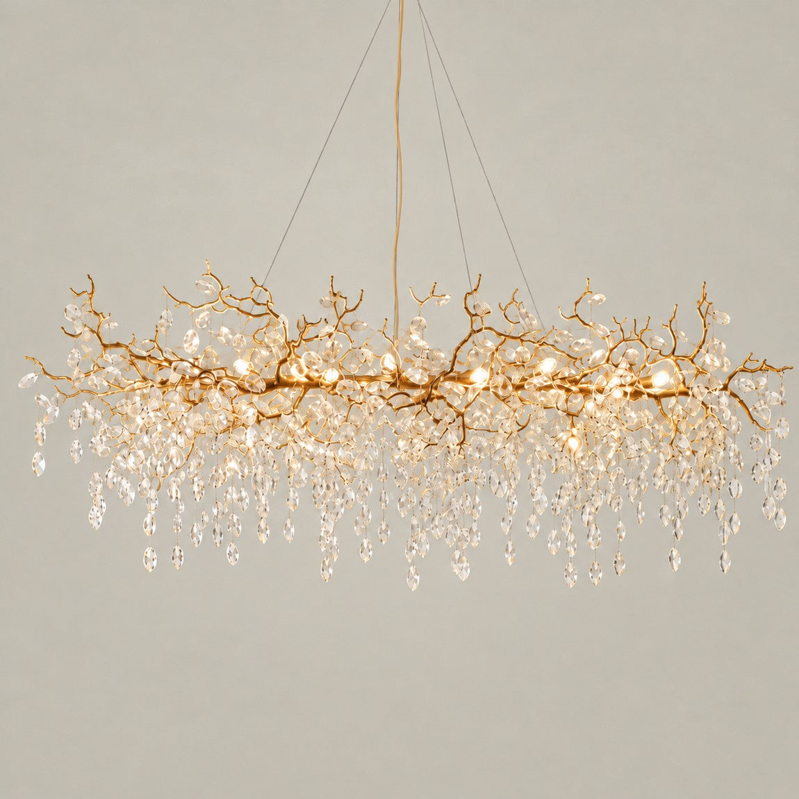 Crystal Chandelier Modern Gold Branch Metal 18-Light for Dining Room on a light warm plaster wall