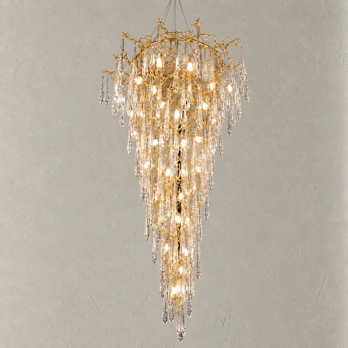 Crystal Chandelier Modern Gold Branch Metal 26-Light for Dining Room on a light warm plaster wall