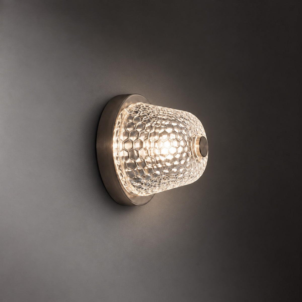Favelia Honeycomb Glass 1-Light Wall Sconce 6.3" on a dark olive wall