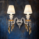 Fulvara Amber Pleated Crystal 2-Light Wall Sconce 16.5" on a dark blue-grey wall