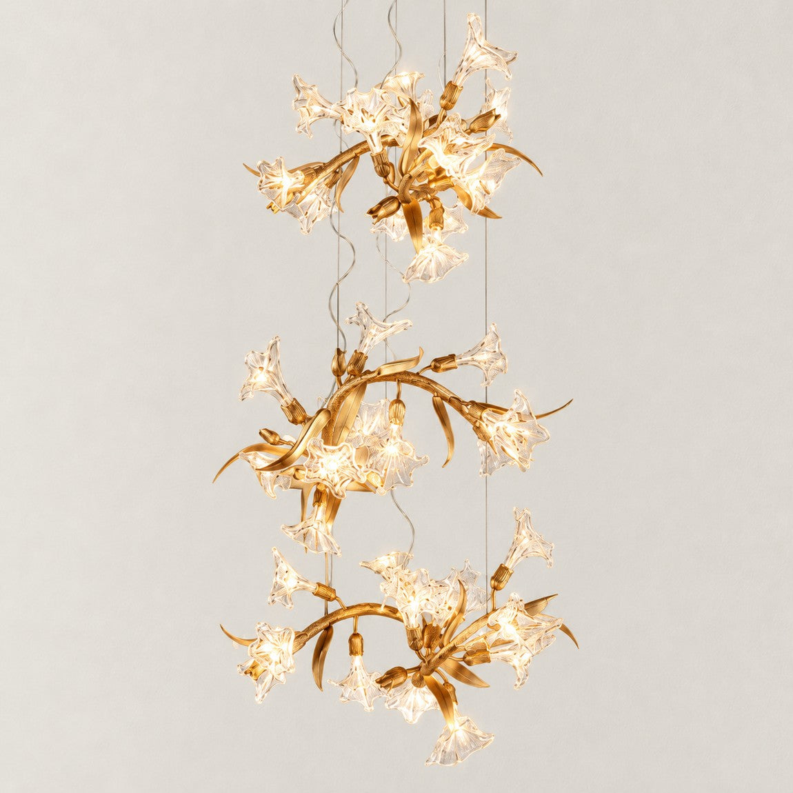 Gold Chandelier Cascading Glass Flower Metal 28.3"L × 108.3"H for Dining Room on a light warm plaster wall