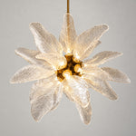 Modern Chandelier Brass Textured Glass Leaf 18-Light for Dining Room on a light warm plaster wall