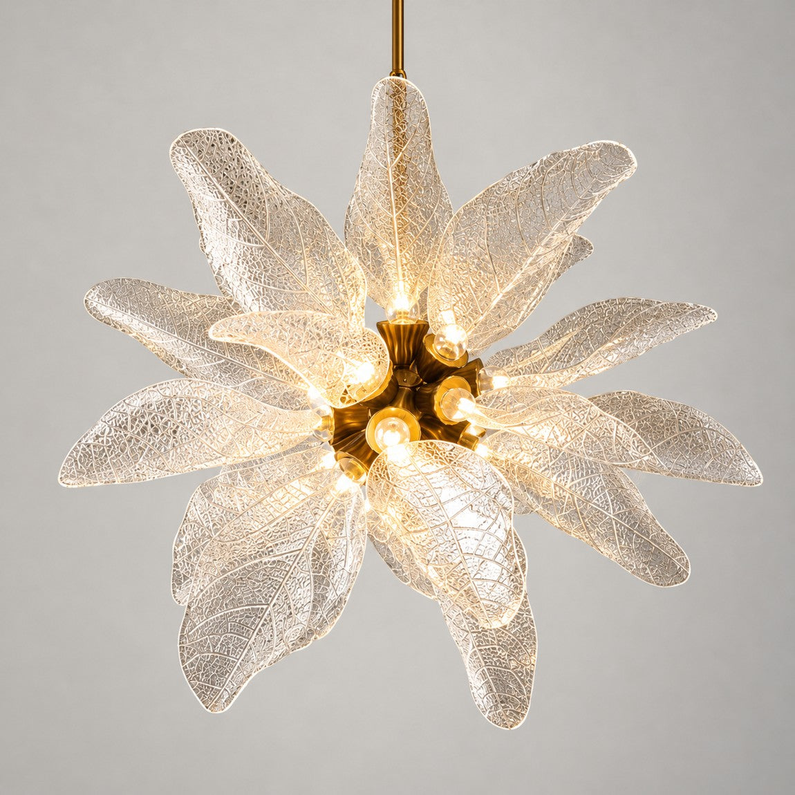 Modern Chandelier Brass Textured Glass Leaf 18-Light for Dining Room on a light warm plaster wall