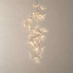 Modern Chandelier Chrome Cascading Glass Flower 40-Light for Living Room on a light warm plaster wall