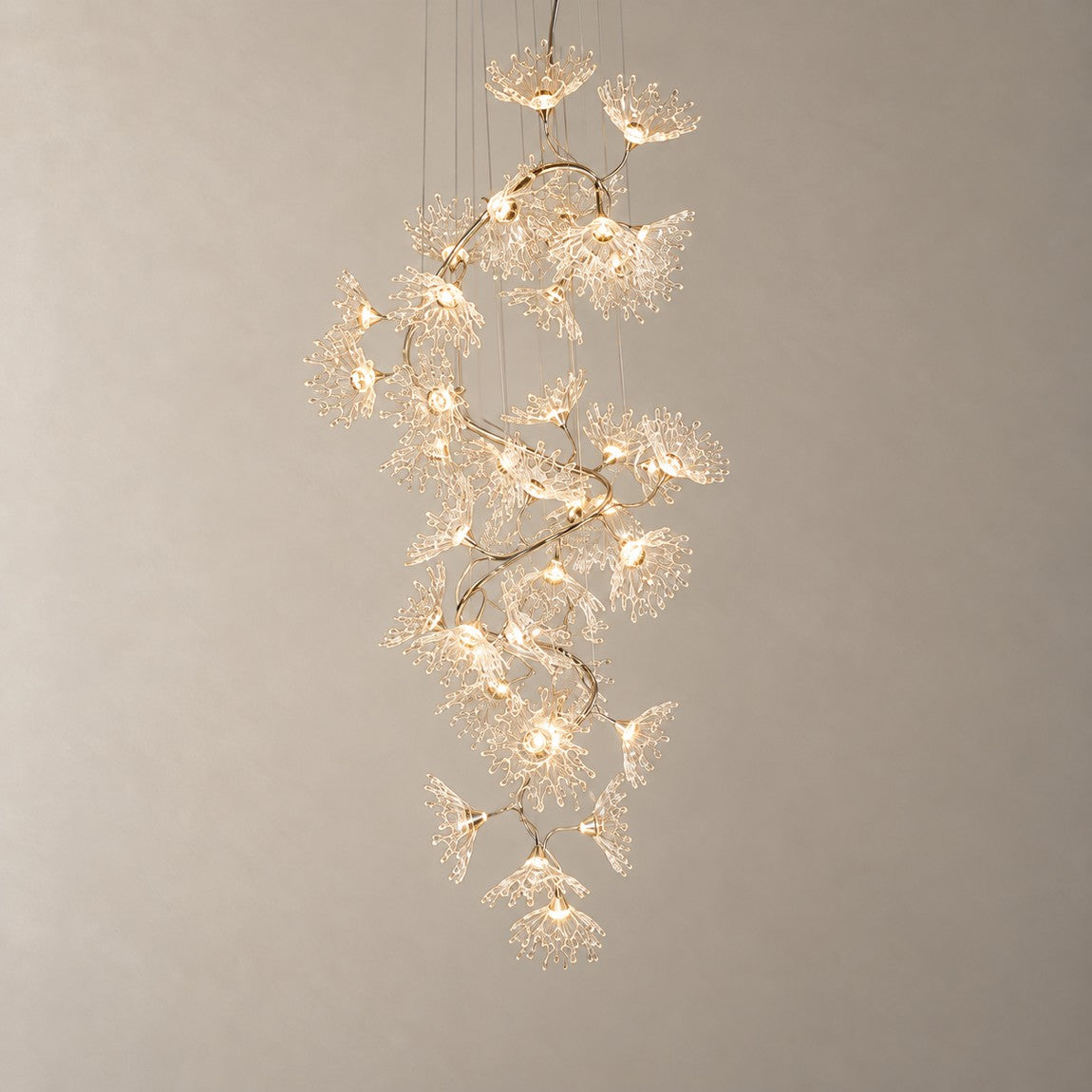 Modern Chandelier Chrome Cascading Glass Flower 40-Light for Living Room on a light warm plaster wall