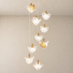 Modern Chandelier Deep Gold Metal Glass Rhinestone 9-Light for Staircase on a light warm plaster wall