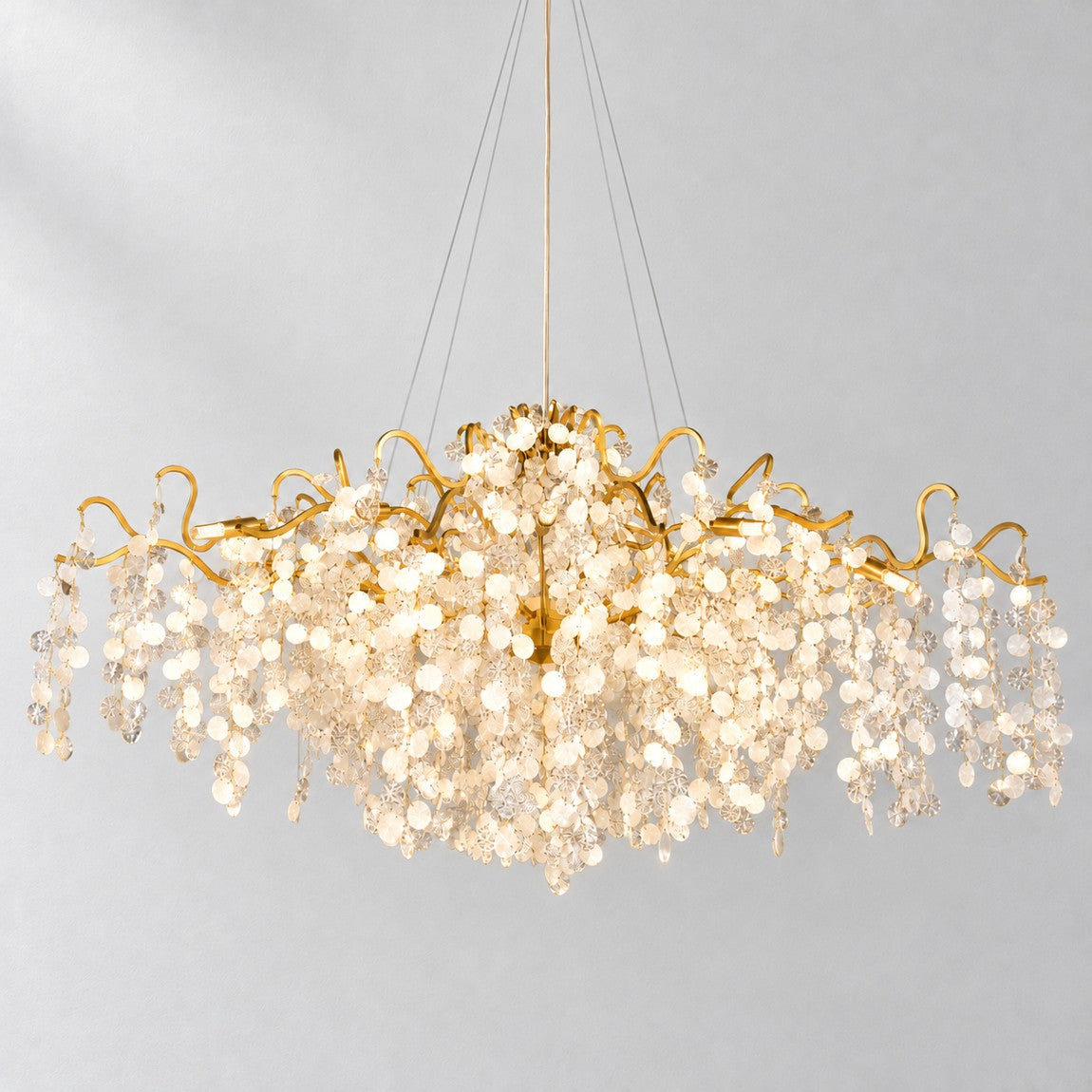 Modern Chandelier Gold Cascading Glass Discs 18-Light 59.1"L for Dining Room on a light warm plaster wall