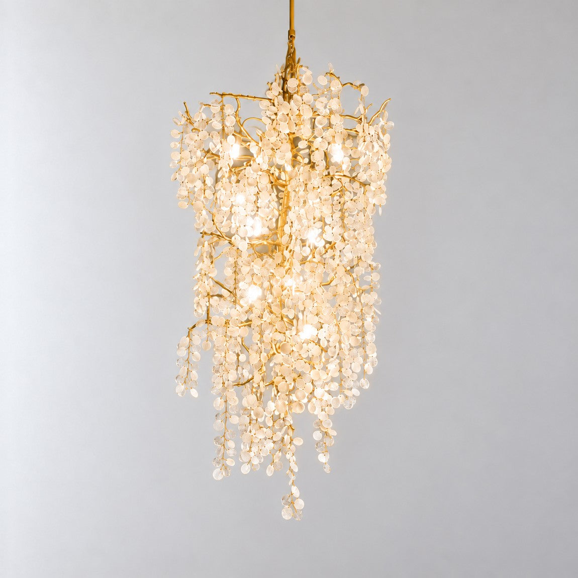 Modern Chandelier Gold Metal Cascading Glass Discs 10-Light for Living Room on a light warm plaster wall