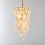 Modern Chandelier Gold Metal Cascading Glass Discs 10-Light for Living Room on a light warm plaster wall