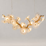 Modern Chandelier Gold Ribbed Glass 16-Light 59.1"L for Dining Room on a light warm plaster wall