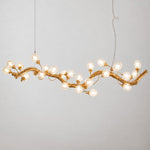 Modern Chandelier Organic Modern Textured Gold Glass 24-Light for Dining Room on a light warm plaster wall