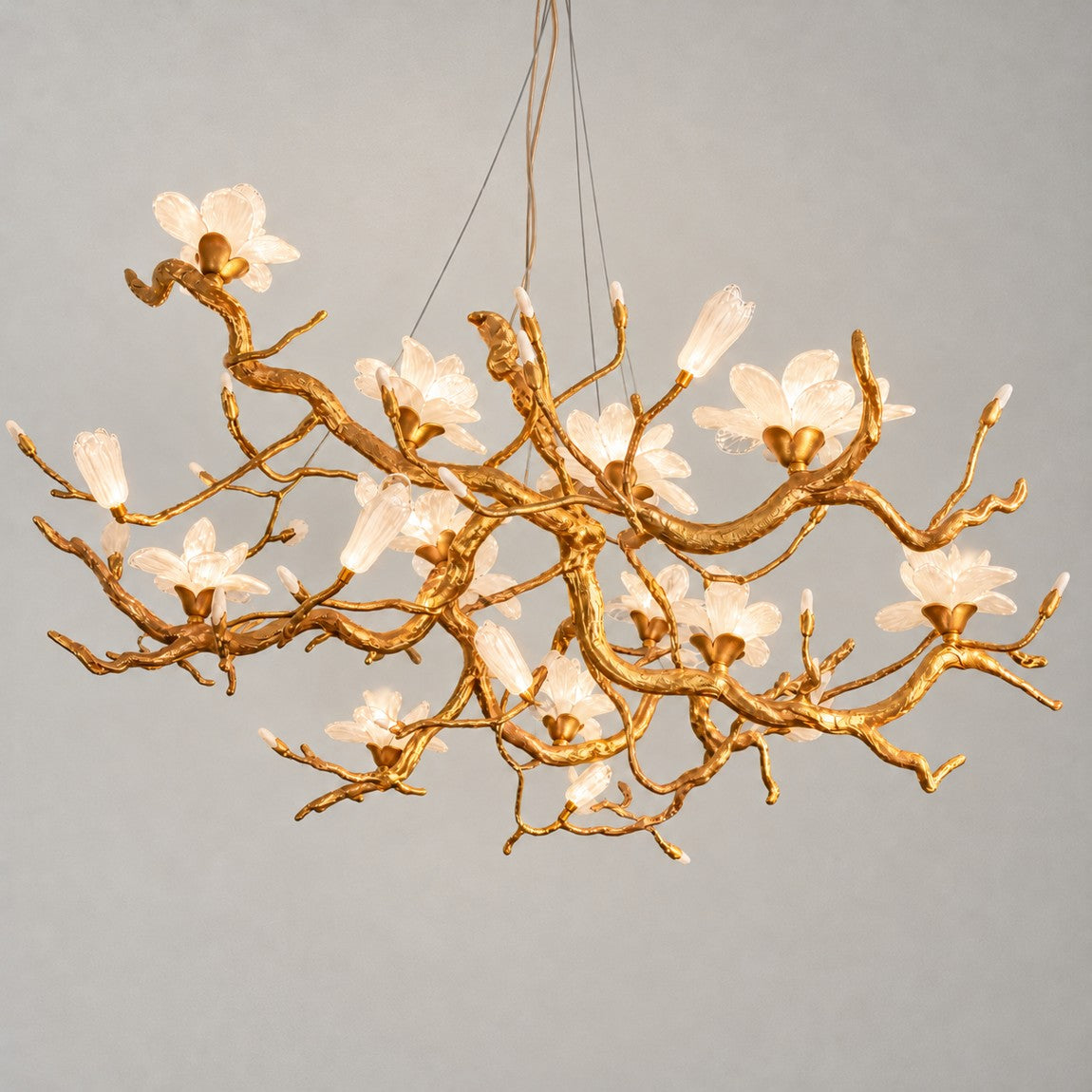 Modern Chandelier Organic Modern Textured Gold Glass Flower 12-Light for Dining Room on a light warm plaster wall