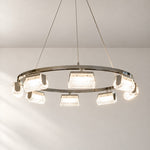 Modern Chandelier Polished Chrome Ring Textured Glass for Dining Room on a light warm plaster wall