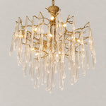Modern Chandelier Textured Gold Glass Drops 15-Light for Living Room on a light warm plaster wall