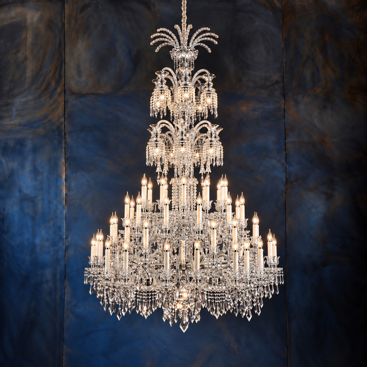 Nolva Chrome Tiered Crystal 73-Light Chandelier 59.1" on a dark blue-grey wall