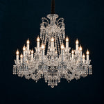 Tavora Clear Candle Crystal 24-Light Chandelier 42.5" on a deep teal-blue wall