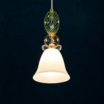 Verdona Green Amber Glass 1-Light Pendant Light 13.8" on a deep teal-blue wall