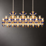 Verenza Amber Glass 46-Light Linear Chandelier 103.5" on a dark olive wall