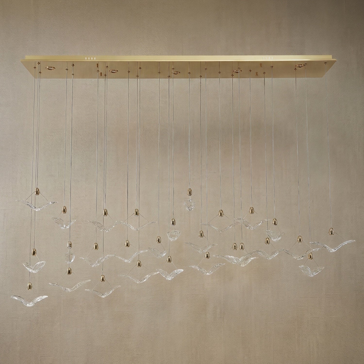 Yiosi Crane handmade cascading glass linear chandelier with antique brass finish — modern dining pendant