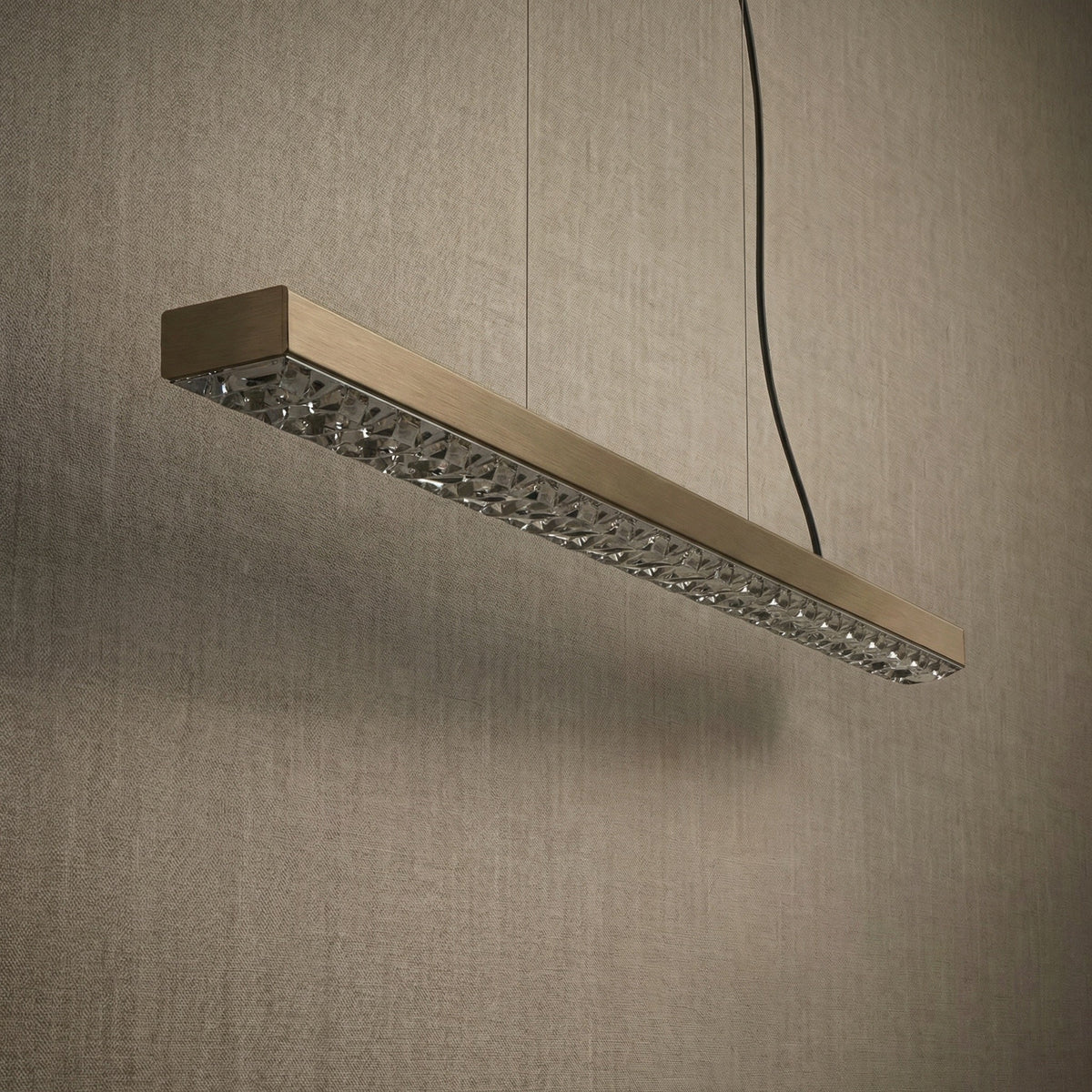 Yiosi Drake 37 inch linear crystal chandelier in modern American dining room with warm ambient glow