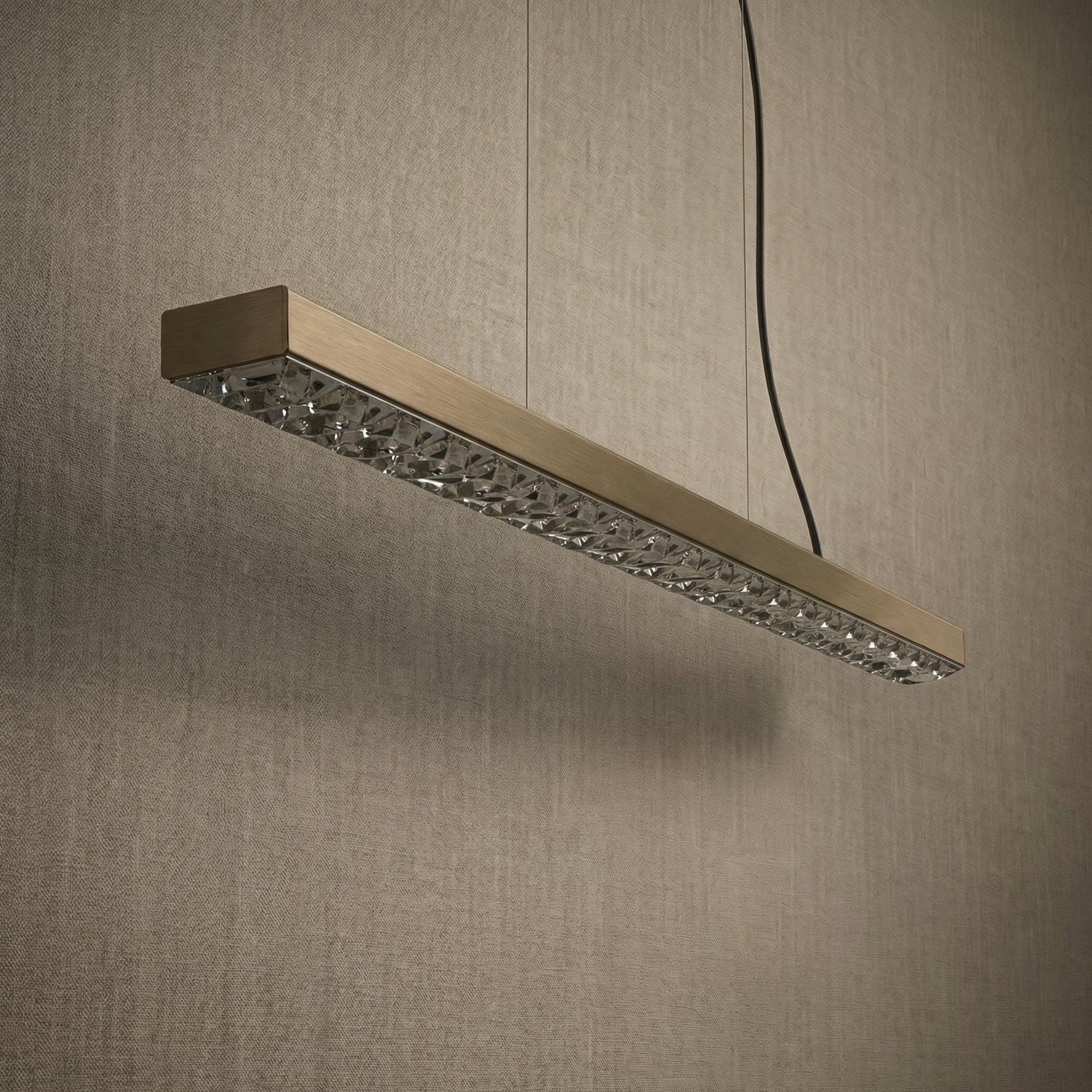 Yiosi Drake 37 inch linear crystal chandelier in modern American dining room with warm ambient glow