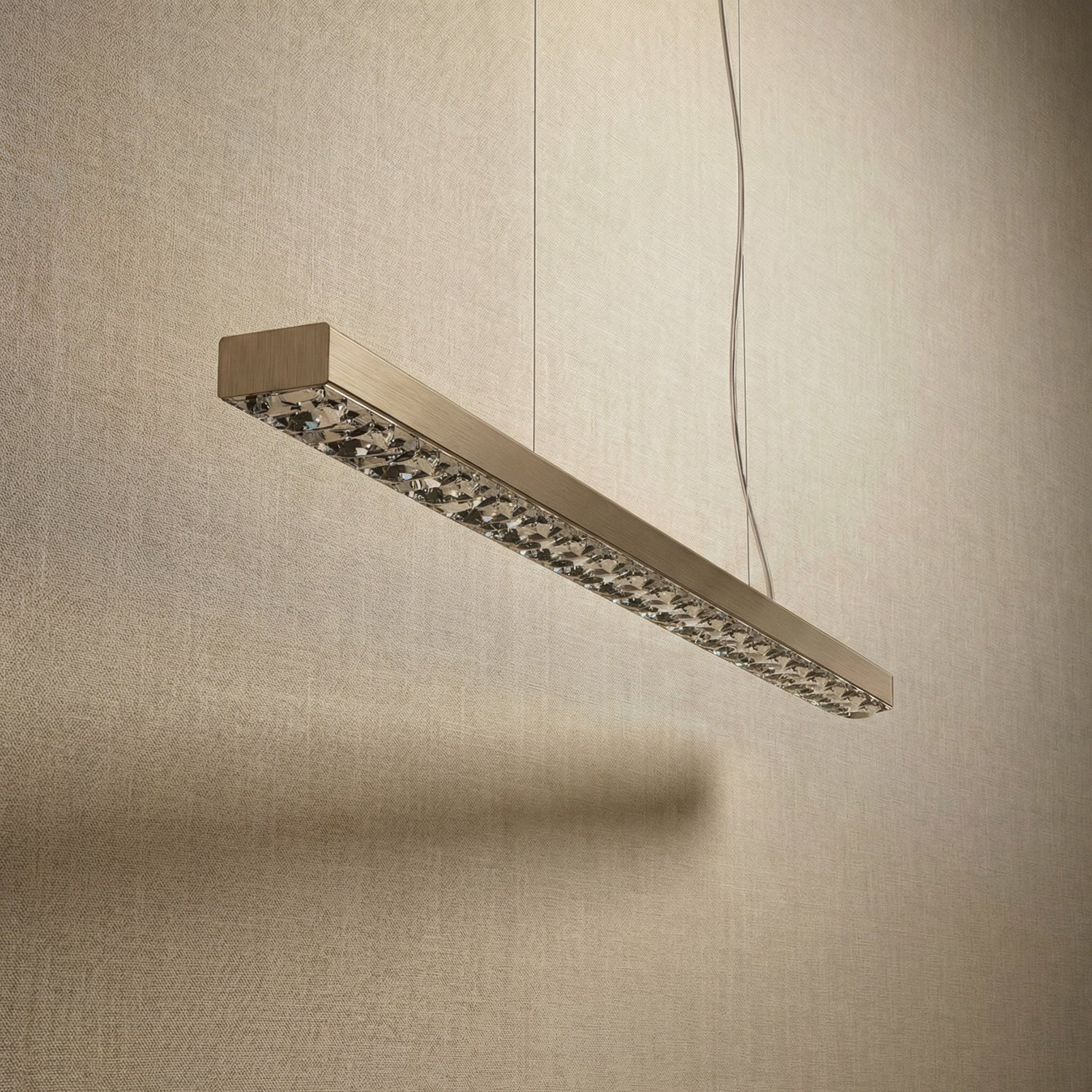 Yiosi Drake 51 inch linear crystal chandelier in modern American dining room with warm ambient glow