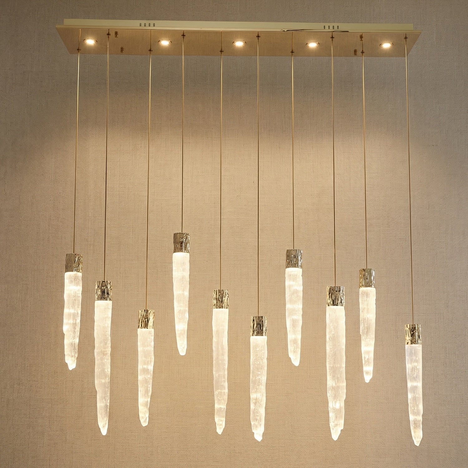 Modern dining room with K9 crystal icicle linear chandelier over long wooden table — Yiosi Halsey 47 inch