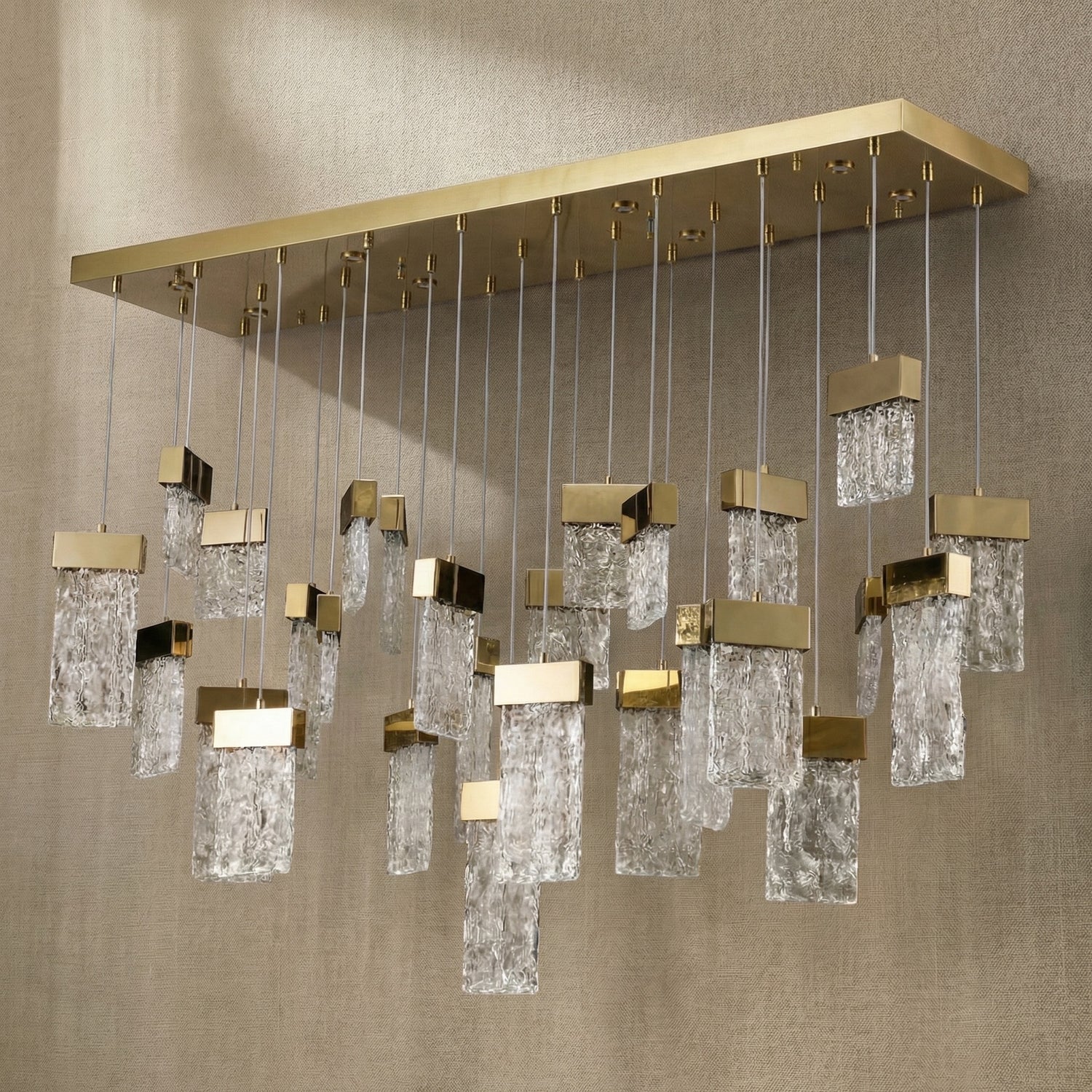 Yiosi Knox 47 inch linear fluted glass chandelier in modern American dining room with warm glow