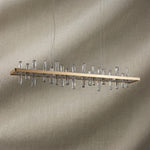 Yiosi Nora 47 inch linear crystal pendant chandelier in modern American dining room with warm glow
