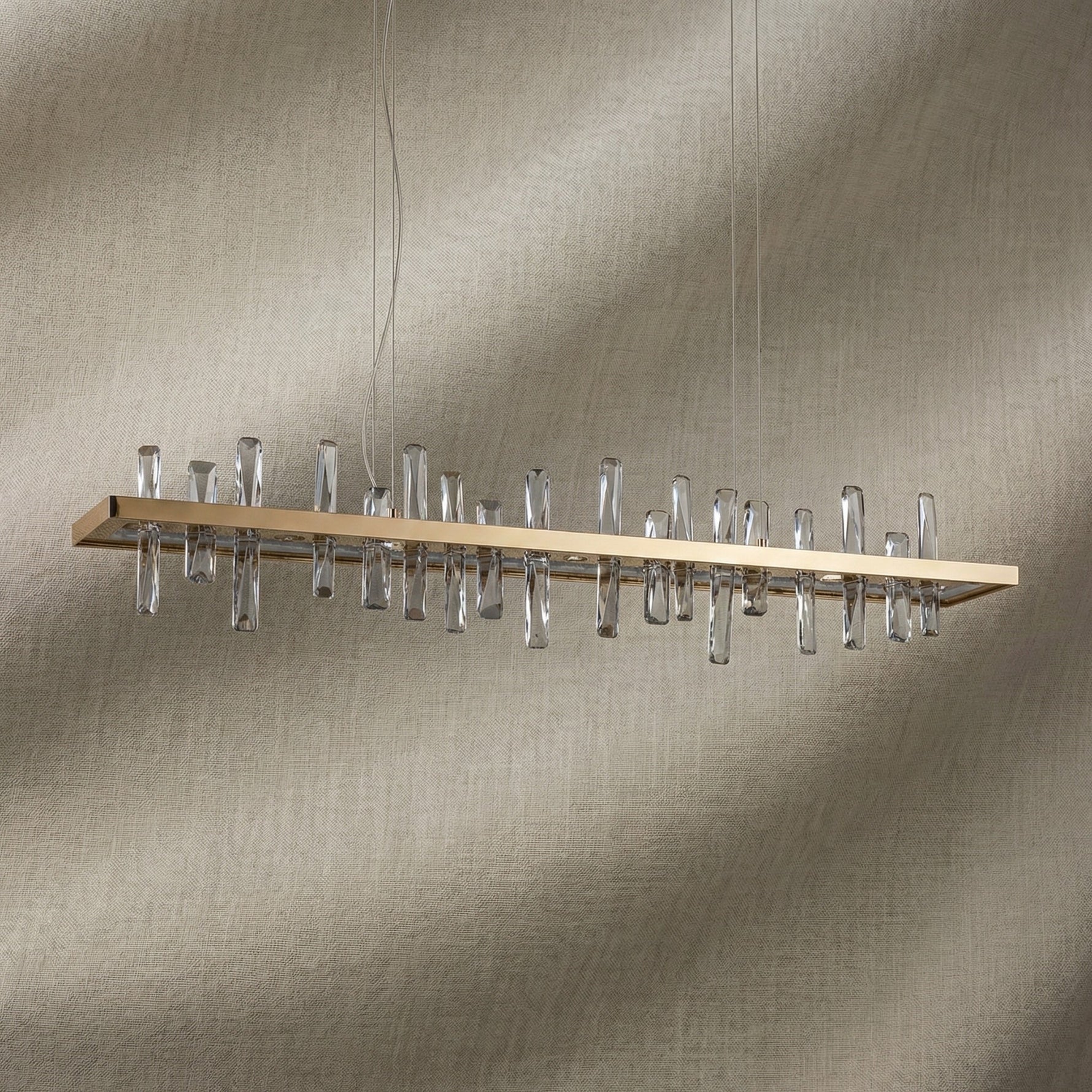 Yiosi Nora 47 inch linear crystal pendant chandelier in modern American dining room with warm glow
