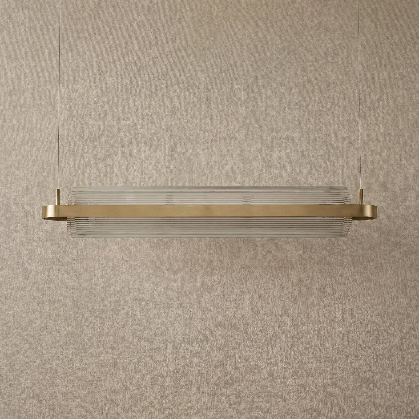 Modern dining room acrylic ribbed glass chandelier over long table — Yiosi Ribbon linear pendant