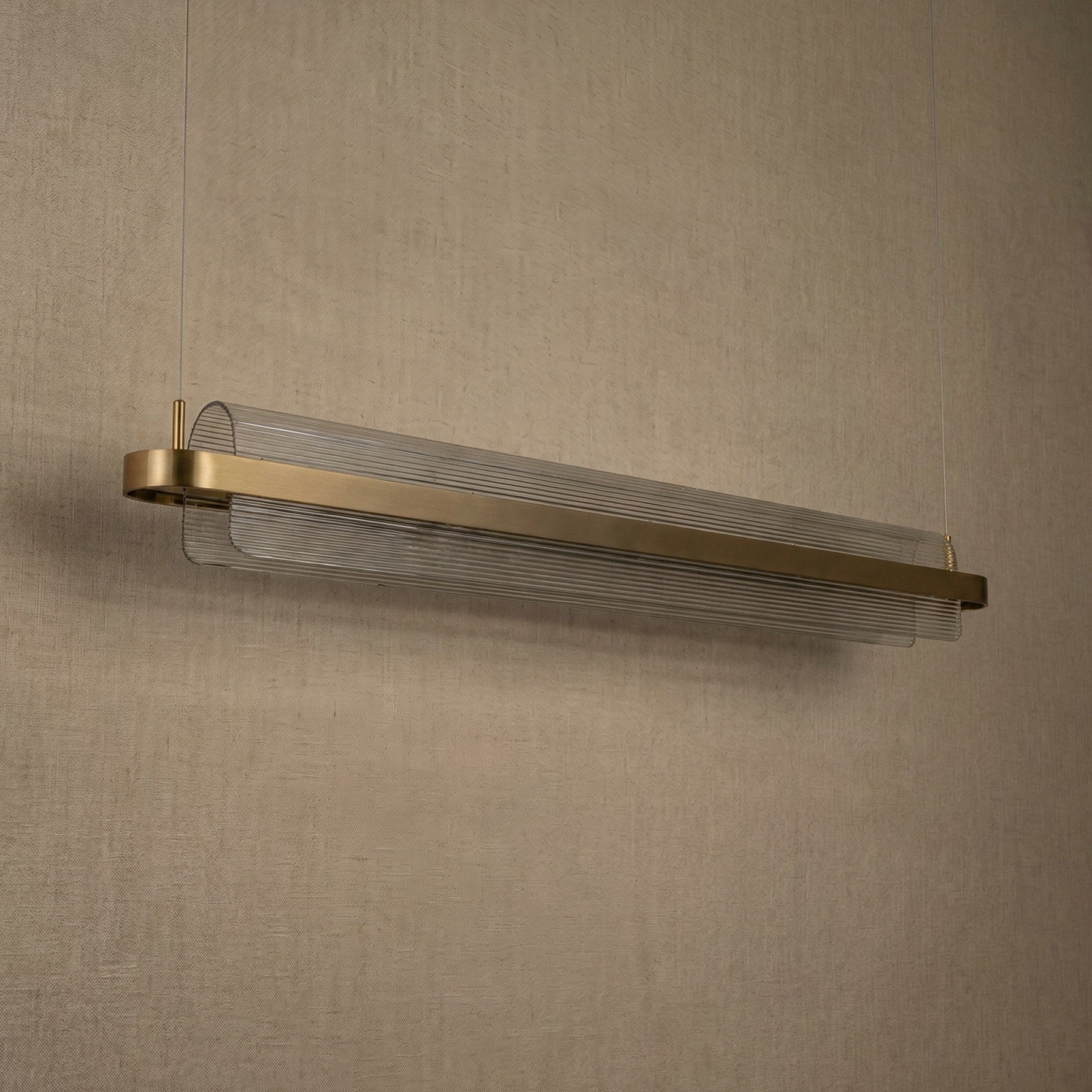 Acrylic ribbed linear pendant over kitchen island marble countertop — Yiosi Ribbon chandelier