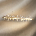 Yiosi Nora 47 inch linear crystal pendant chandelier with champagne gold finish — modern dining pendant