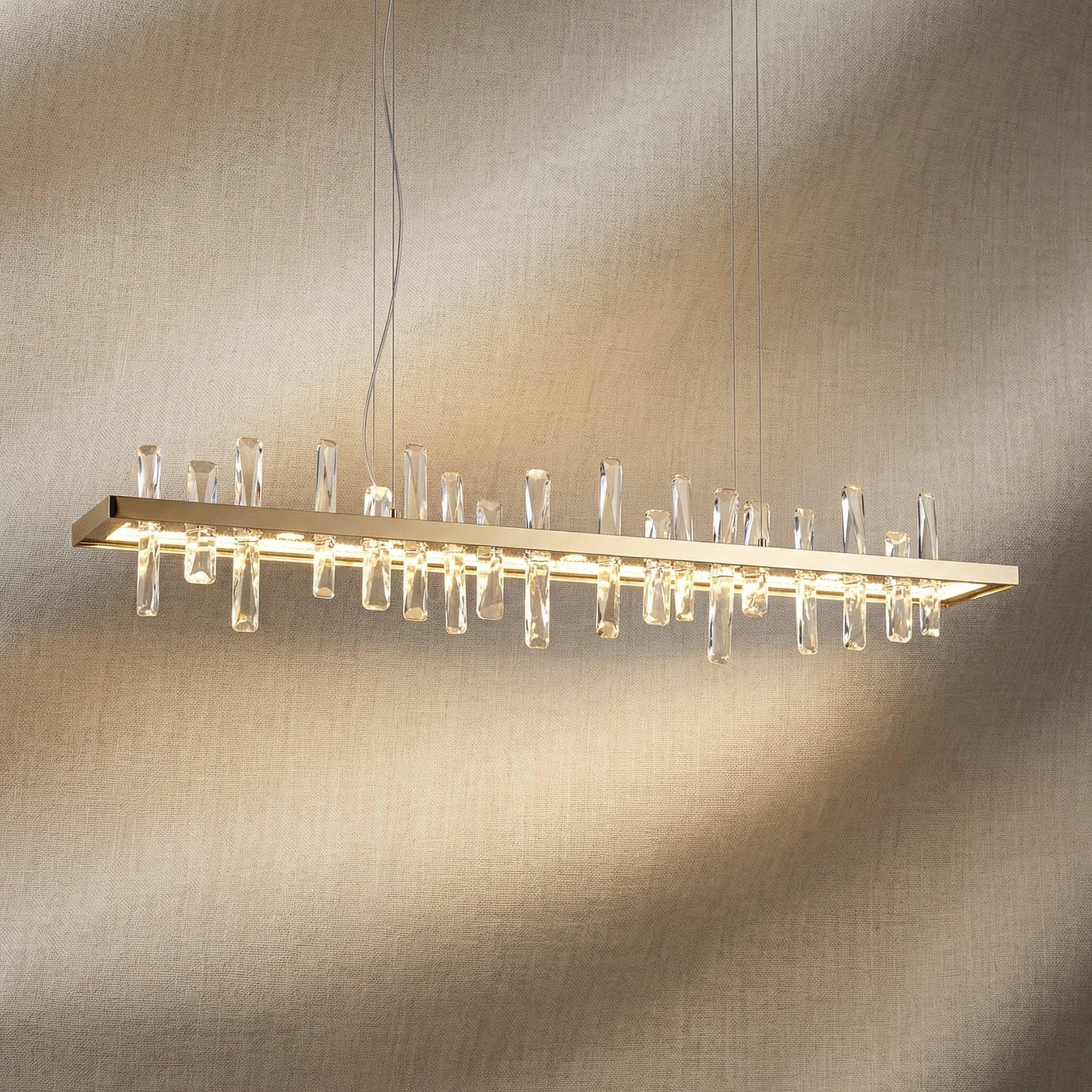 Yiosi Nora 47 inch linear crystal pendant chandelier with champagne gold finish — modern dining pendant